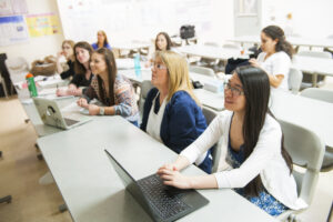 Students sitting in a classroom learning.